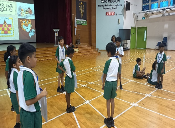 Students taking part in a Tamil language group activity in the school hall.
